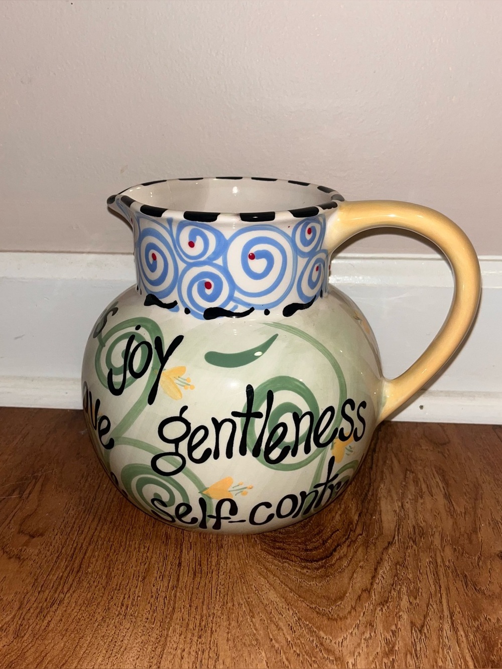 Hand-Painted Ceramic Pitcher with Yellow Handle and Green Motifs